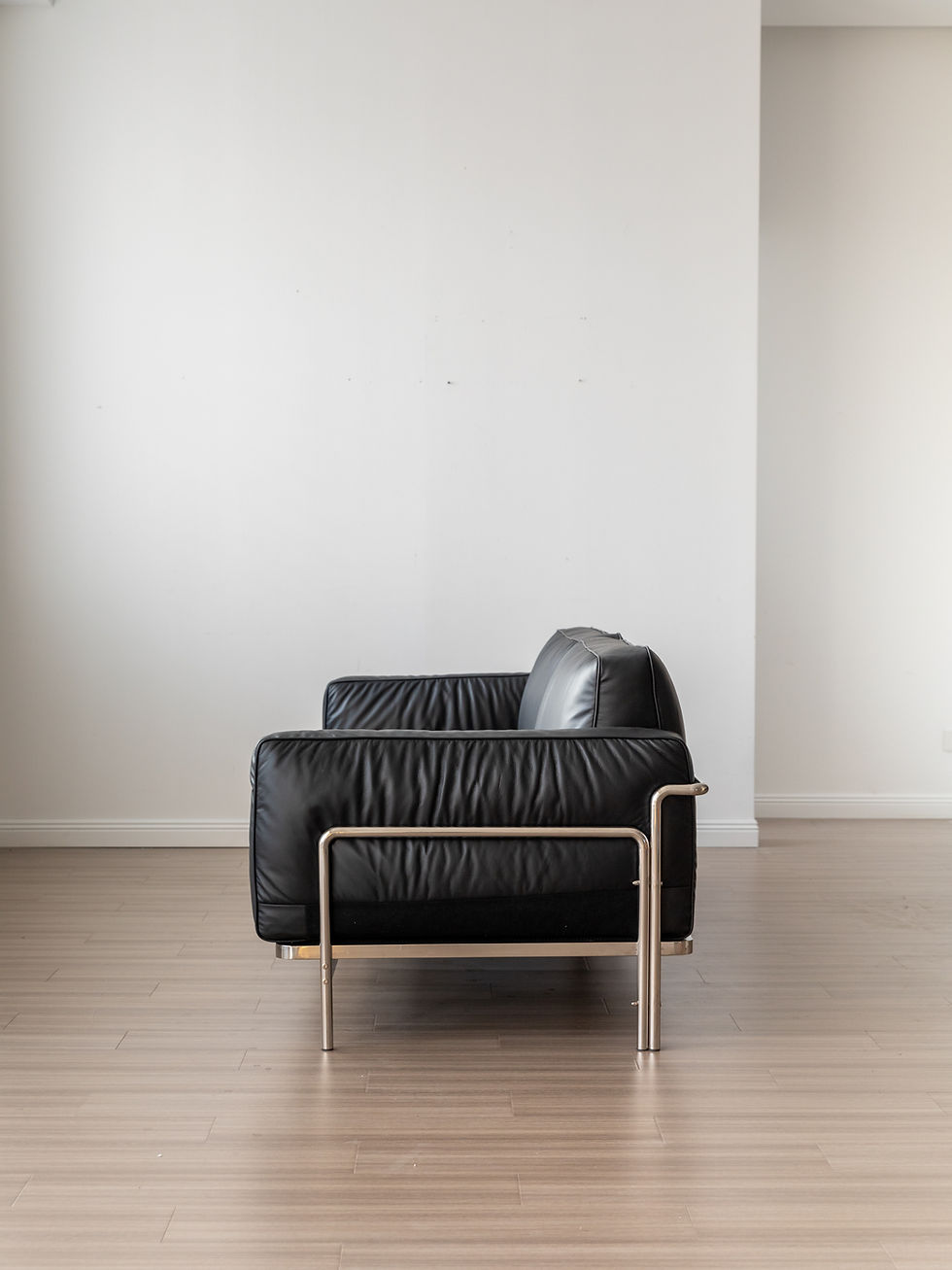 Thumbnail: Klaus Black Leather & Chrome Sofa – side profile, highlighting deep cushions and sleek chrome base