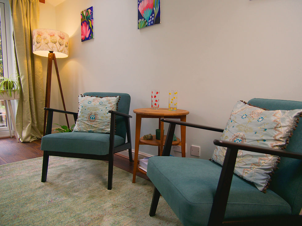 In-person and online therapy practice office with teal chairs.