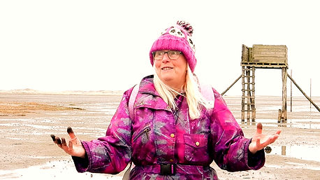 The artist A LamBing Art is walking the Pillgrims way to holy Island covered in mud.