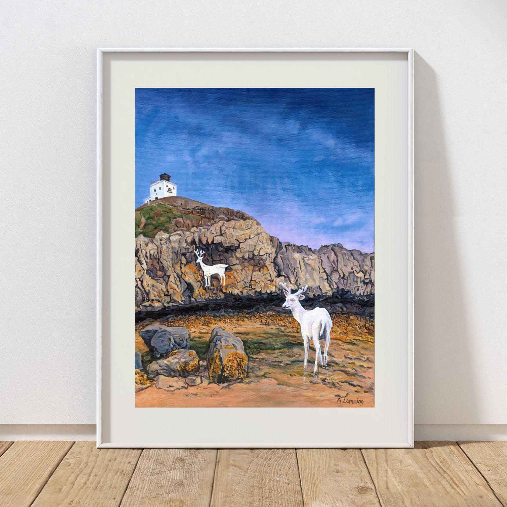 Stag rock Bamburgh with a white stag looking at a rock painting of a stag.