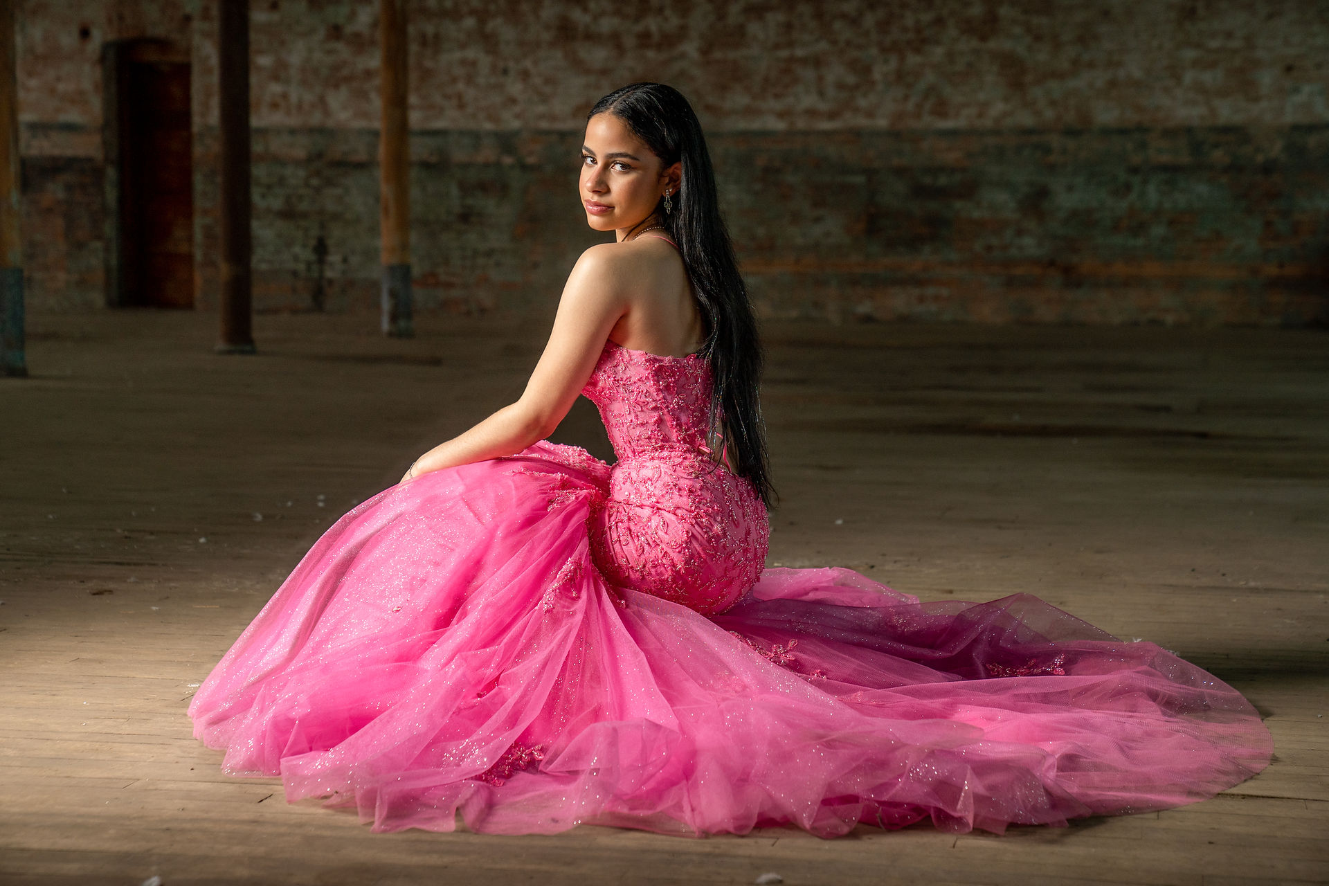 Senior girl wearing hot pink tulle prom dress for senior portraits