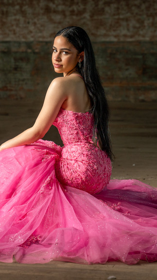 Senior girl wearing hot pink tulle prom dress for senior portraits