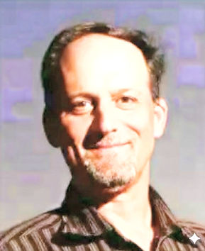 A headshot of Geoff Marcy, a professor of physics and astronomy who is also an avid tennis player.