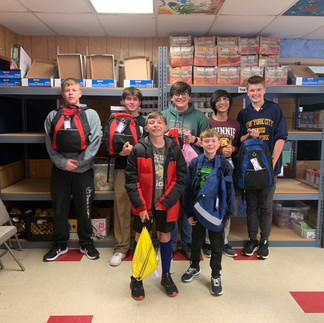 Fighting Hunger Together Young volunteers pack backpacks full of nutritious food ensuring no child goes hungry on weekends