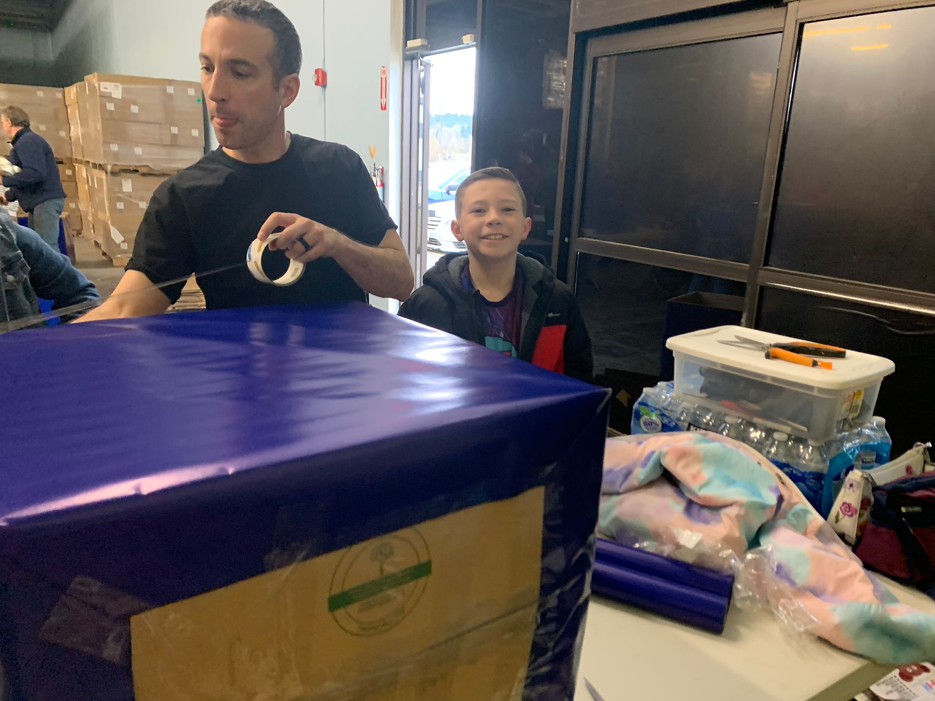 Shopping cart overflowing with food donations for kidzz helping kidzz drive
