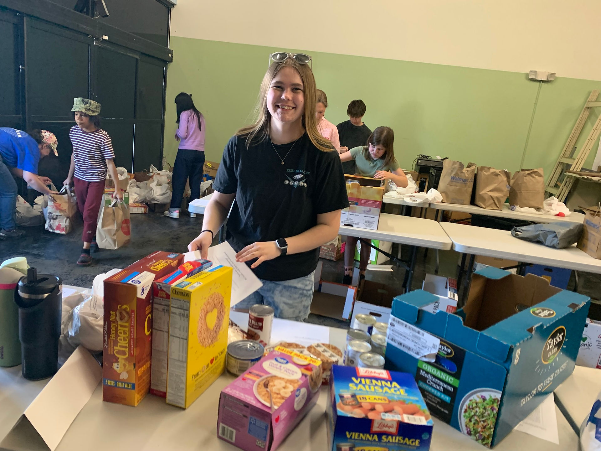 Food sorting at Kidzz Helping Kidzz Food Drive 2025. Volunteer organize item.