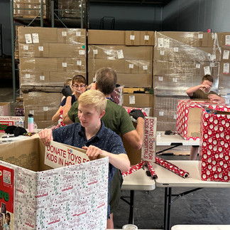 Young volunteers at Kidzz Helping Kidzz prepare toy donation boxes for children in need
