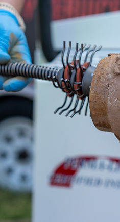 cleaning cast iron sewer lines with a chain machine,  preparing to reline the piping using