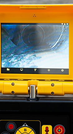 A drain cleaning company checks a blocked drain with a camera before flushing it out. Scre
