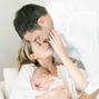 New parents holding their baby.