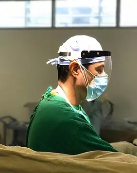 Dr. Hernán Guerrero performing a urological procedure in the operating room.