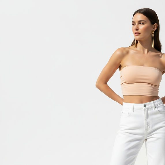 Image of a woman wearing a bandue top that covers her stomach in light peach colour and we