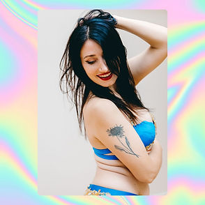 A young woman poses in blue underwear