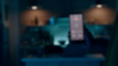 person-holding-mobile-phone-with-high-tech-application-in-smart-house-features-controlling