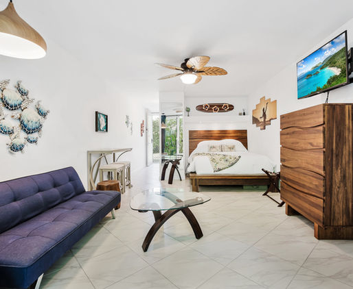Luxury vacation condo living room at Sanctuary Spaces Hawaii in Kailua-Kona featuring tropical décor and open layout