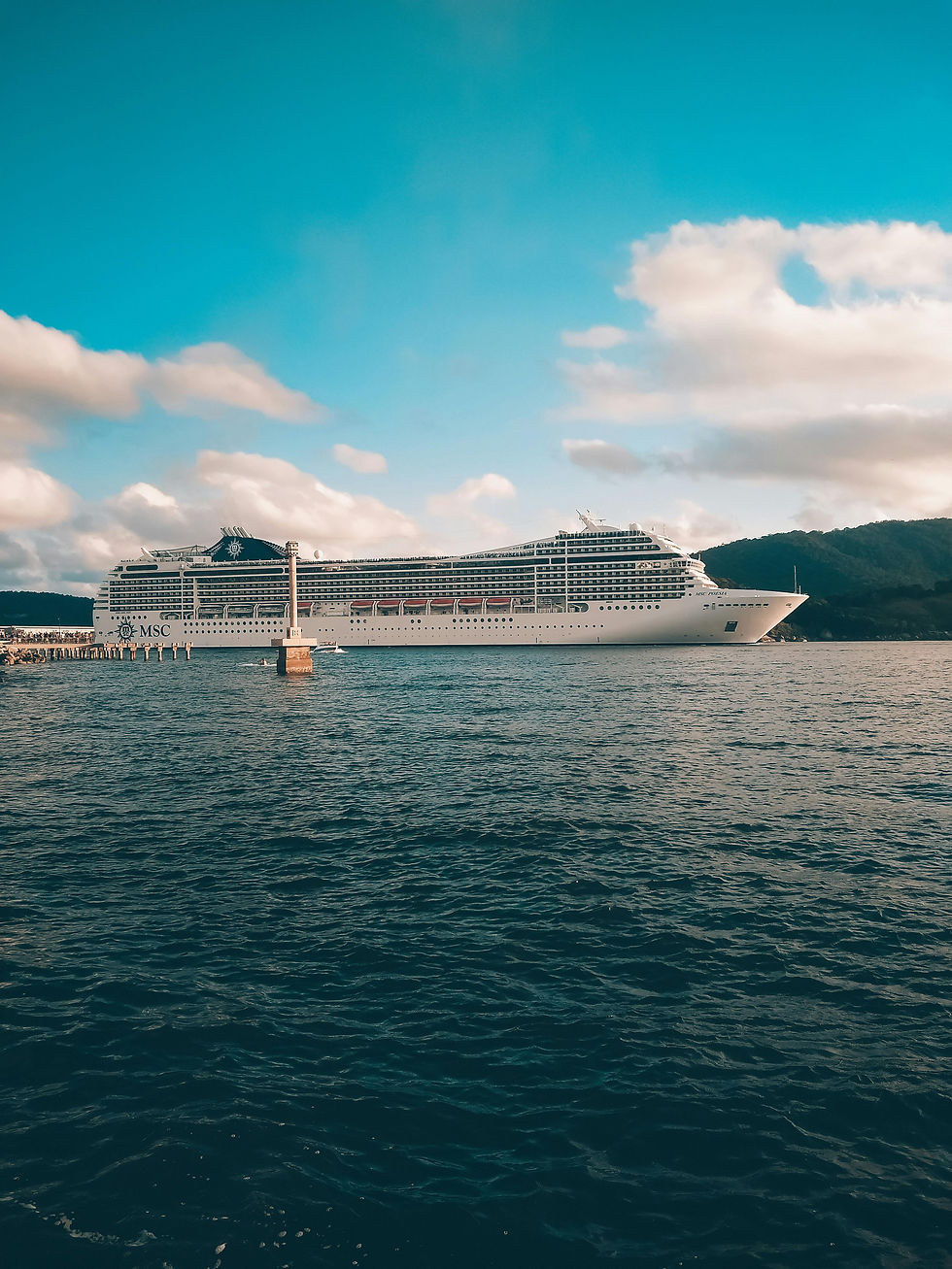 large cruise ship with blue sky beyond