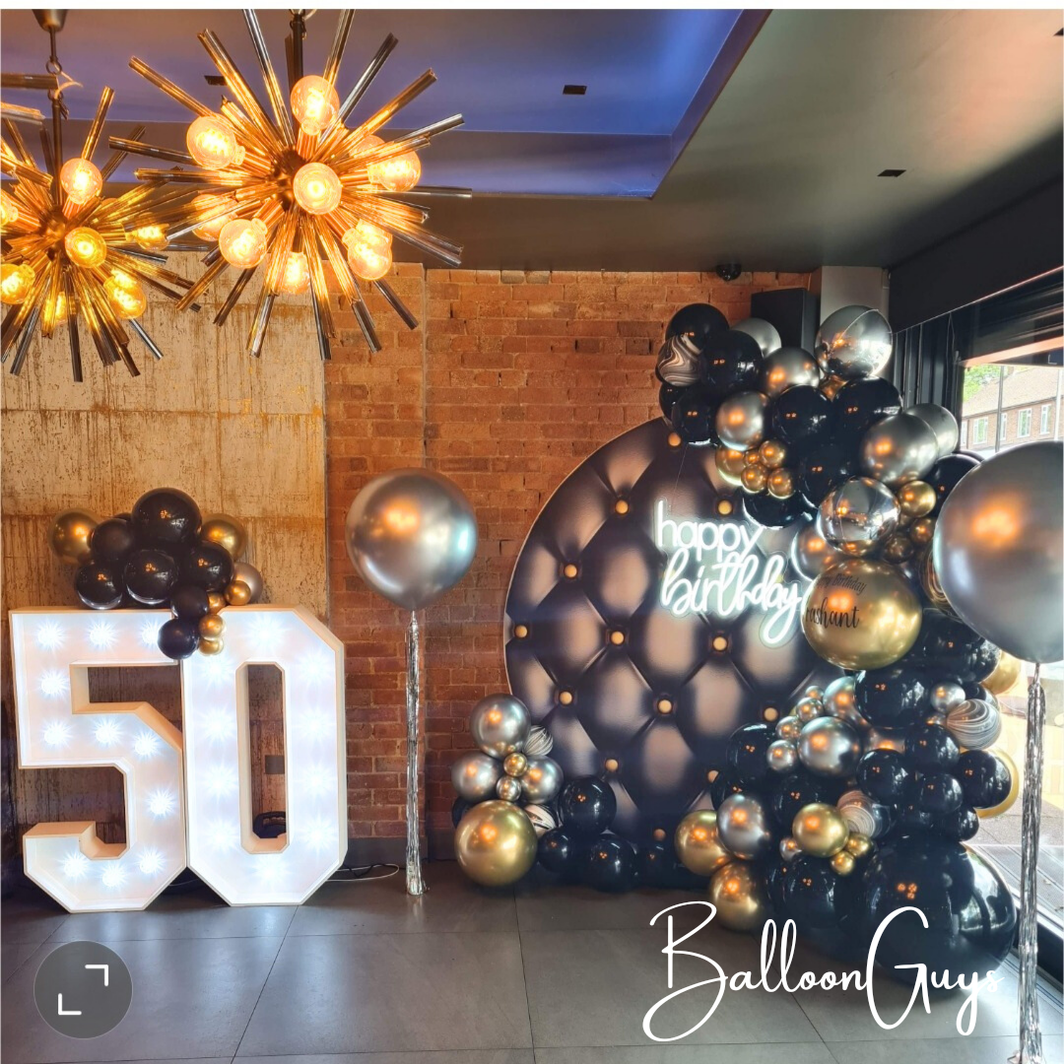 GOLD BLACK AND SILVER BACKDROP AND BALLOONS