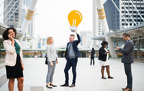 Key company players showing peak performance standing in the middle of tall office buildings