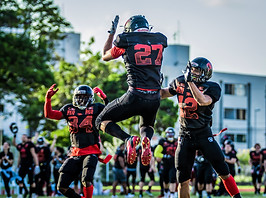 football players jumping up together