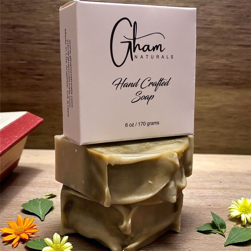 Stacked Gham Naturals soap bars with packaging, hand crafted soap, and flowers.