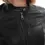Thumbnail: A woman wearing a black leather jacket, close up view — By Kani.