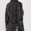 Thumbnail: A woman wearing a black leather biker jacket—back view.