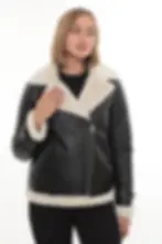 A woman wearing a black shearling jacket with white fur interior, front view (1) — By Kani.