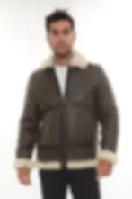A man wearing a brown shearling jacket, front view (1) — By Kani.