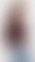 A woman wearing a burgundy leather jacket.