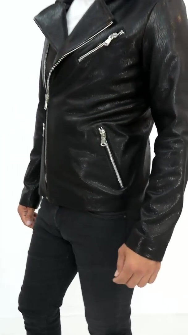 Thumbnail: Studio video of a male model wearing a black leather biker jacket, full and close-up views — By Kani.