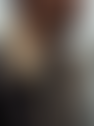 Eye-level view of a men's shearling aviator jacket hanging on a rack