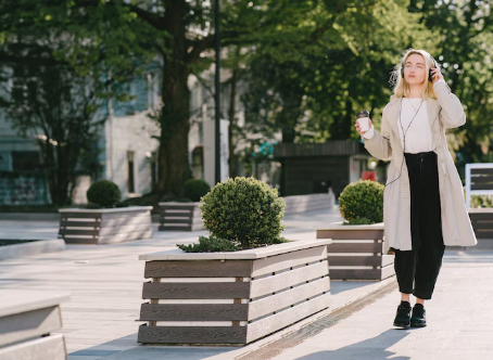 Woman enjoying a modern urban space featuring Urban Pot’s commercial planters, designed for both aesthetics and functionality.