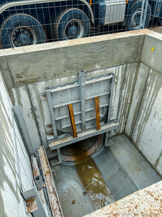 Technisches Bauwerk mit Schieber zur Regelung von Abflussmengen im Kanal- und Wasserbau