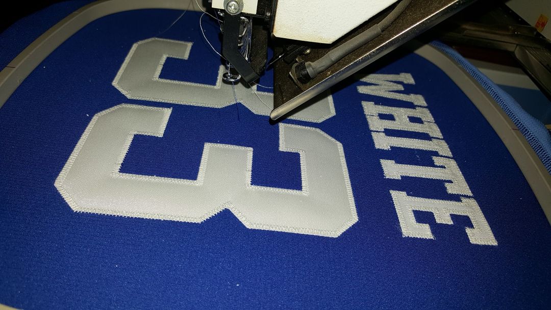 Uniform with sewn tackle twill lettering