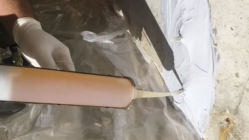 Close-up view of foundation crack being sealed by professional