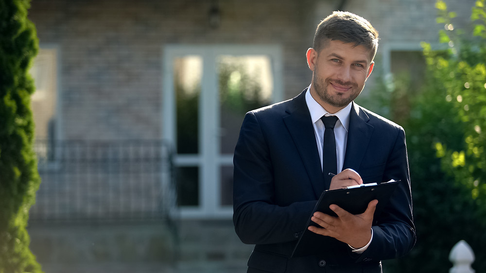 A Celina, TX real estate agent making notes on a clipboard.