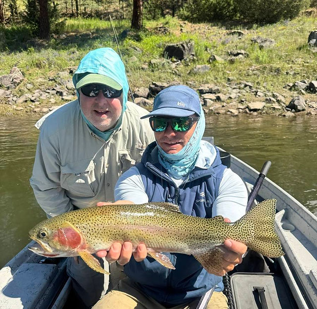 Scott holding a 21" rainbow caught on the clark fork river 