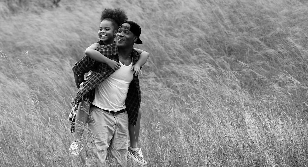 African American man holding his daughter.