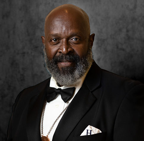 Professional Headshot of a Male wearing a formal tux with a multitone black background