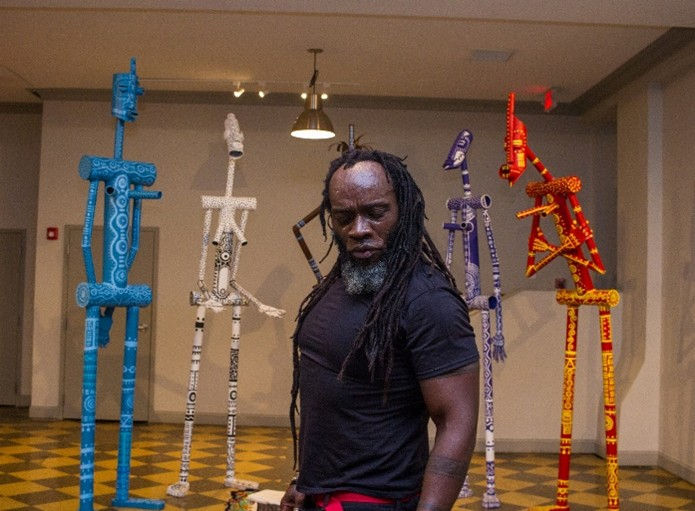 Iyaba with some of his sculptures