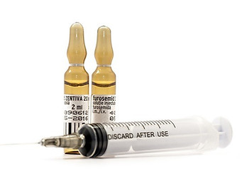 Two bottles of medicine and one syringe