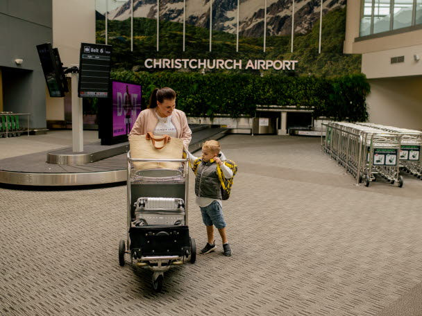 image of mother and child in christchurch airport baggage claim