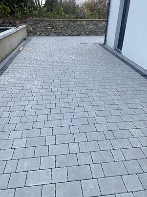 A brick driveway in various colors, including red, gray, and brown