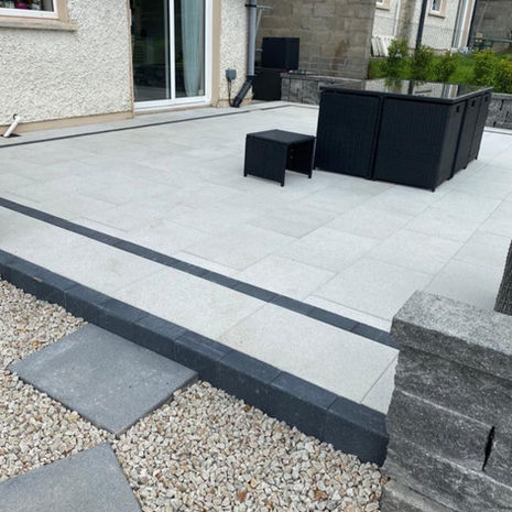 Newgrange Silver Granite patio with Connemara Raven/White walling and Damson border brick edging.