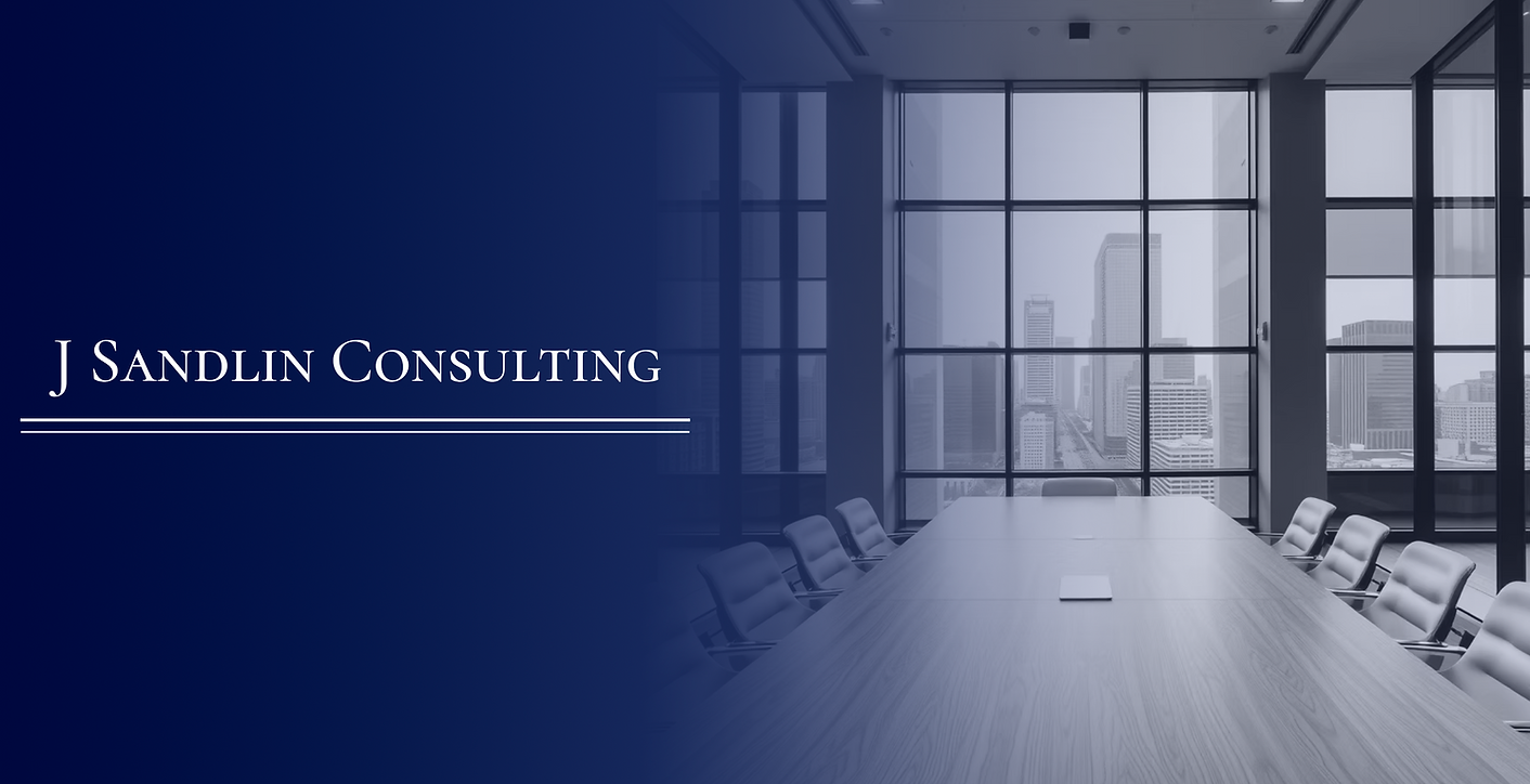 J Sandlin Consulting's logo over a board room which overlooks the city.