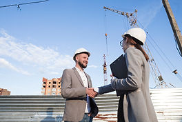 smiling-engineers-shaking-hands-construction-site-architectural-project.jpg
