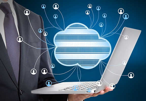 close-up-businessman-hand-holding-laptop-with-abstract-cloud-computing-hologram-blurry-blu