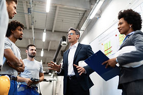 factory-manager-holding-meeting-talking-his-employees-about-project-plans.jpg