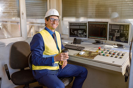 cheerful-male-engineer-with-coffee-cup-working-factory.jpg