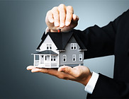 male-hands-holding-house-model-background.jpg